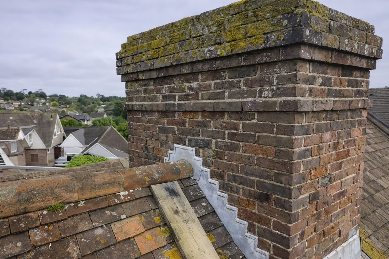 chimney in need for repointing weathered bricks
